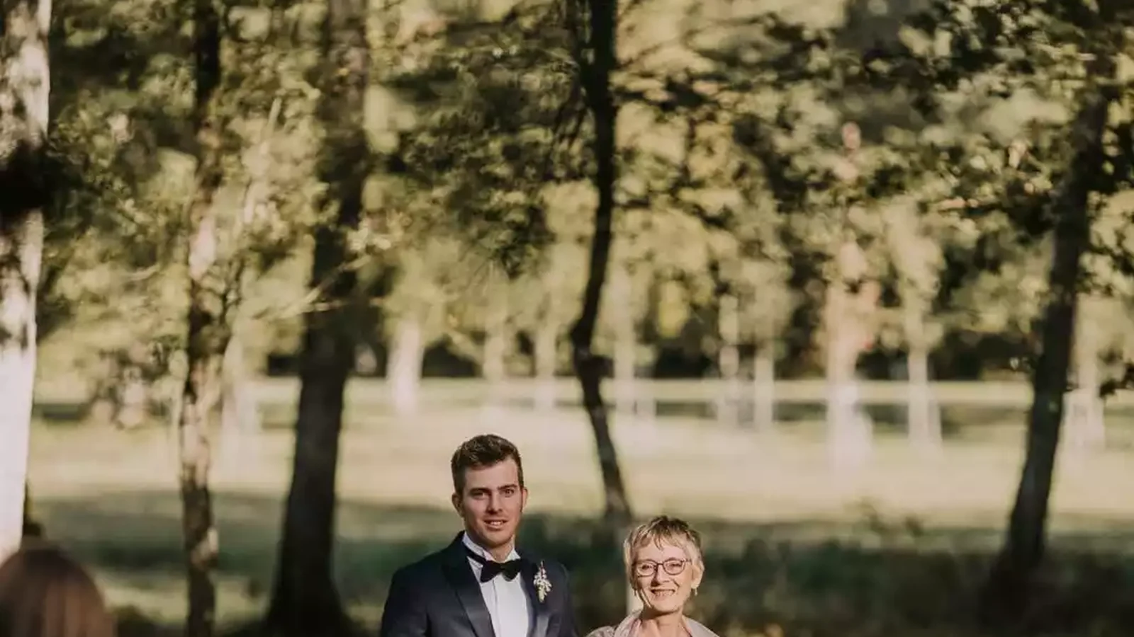 Mère du marié de 50 ans accompagnant son fils lors d'une cérémonie en extérieur