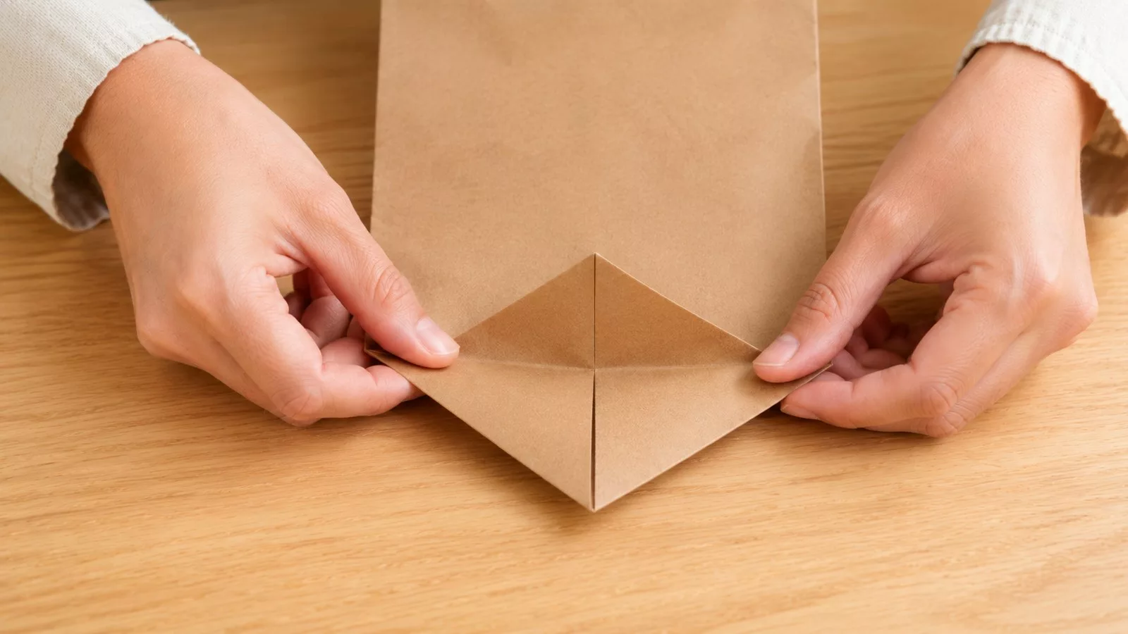 Replier les coins de la base du sac vers le centre pour aplatir le fond
