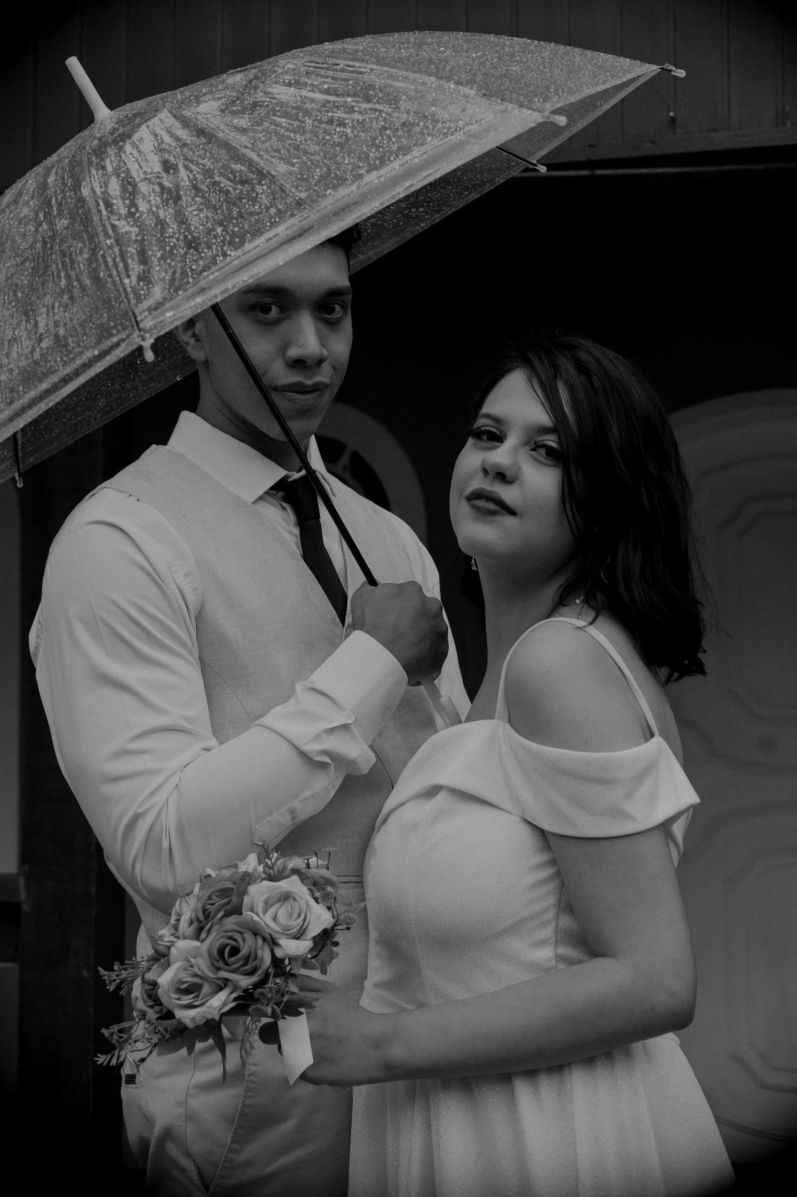 Couple de mariés sous parapluie, portrait noir et blanc